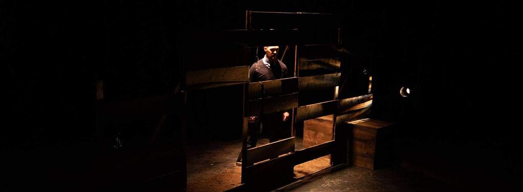 Photograph from We Like It Here - lighting design by Alan Mooney